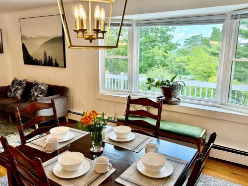 a dining room with a table and chairs and a window at The Yuzu stunning mountain retreat with hot tub in Gardiner