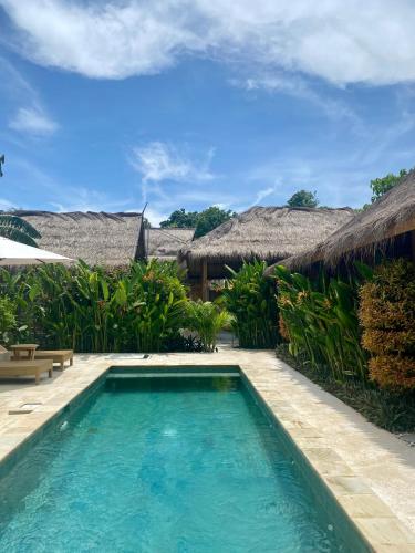 a swimming pool in front of a villa at My Island Home Gili Air in Gili Air