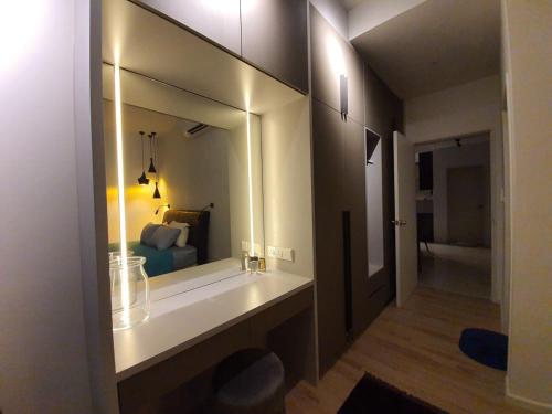 a bathroom with a mirror and a bed in a room at LoveStayBangi - Lake View, Sunway Gandaria, Bangi in Bandar Baru Bangi