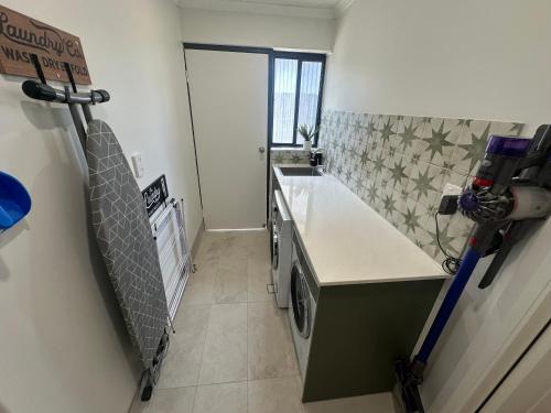 a kitchen with a sink and a stove at Central Cullen Wagga Apartments in Wagga Wagga