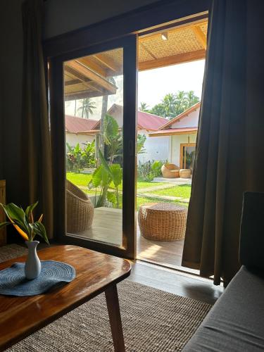 a room with a glass door leading to a patio at ANITSA RESORT in El Nido