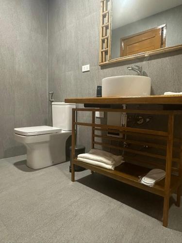 a bathroom with a toilet and a sink and a mirror at ANITSA RESORT in El Nido