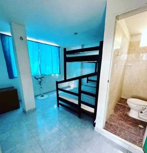 a bathroom with a bunk bed and a toilet at Hotel shalom taganga in Taganga