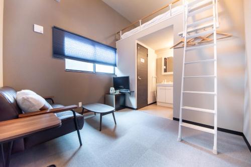 a bedroom with a loft bed and a living room at LOCO Minamiichi in Nara