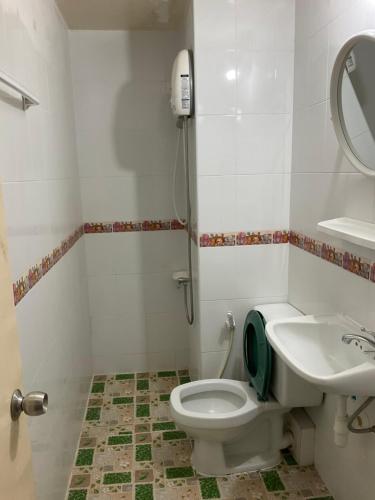 a bathroom with a toilet and a sink at Dailyroom by Anna T1-T12 in Nonthaburi