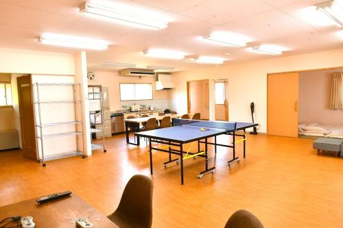 a large room with a ping pong table in it at LINDA Guest House -- Great for long term stay with family and friends!Enough Playing Guest House in Iida