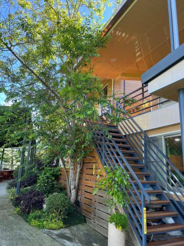 a staircase on the side of a building with a tree at Tianen Farm in Hualing