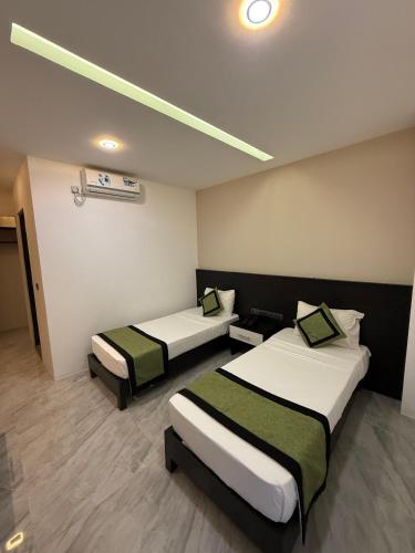 a room with two beds in a room at Ruvisha Beach Hotel in Negombo