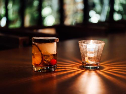 two glasses sitting on a table with a drink at Mercure Hida Takayama in Takayama