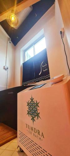 a sign on a wall in a room at Habyt Kada at Maxwell in Singapore