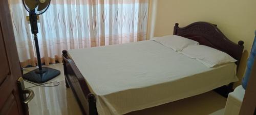 Postel nebo postele na pokoji v ubytování Suduganga inn