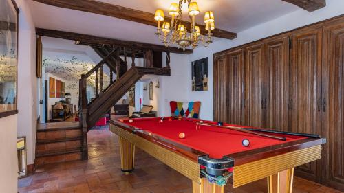 a room with a pool table and a chandelier at 17th Century Room in Villa with Snooker & HotTub - Sintra WOW in Sintra