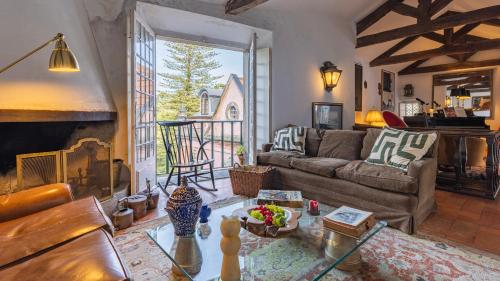 a living room with a couch and a fireplace at 17th Century Room in Villa with Snooker & HotTub - Sintra WOW in Sintra