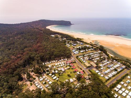 an aerial view of a resort next to a beach at Durras Lake North Holiday Park in Durras