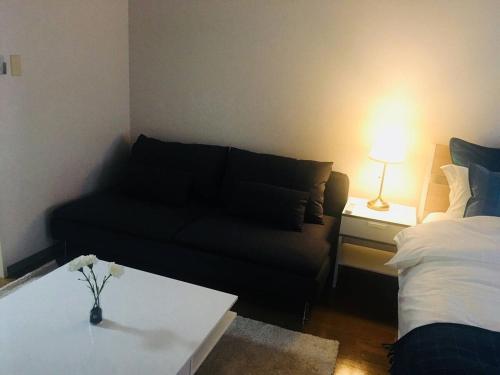 a living room with a couch and a coffee table at Apartment in Narita 101 in Narita