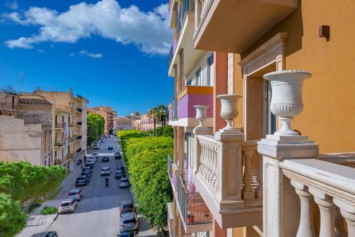 a balcony of a building with cars parked on the street at La Paloma Blanca Hotel in Sciacca
