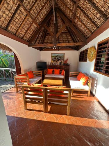 a living room with a couch and a table at La Parenthèse in Nosy Be