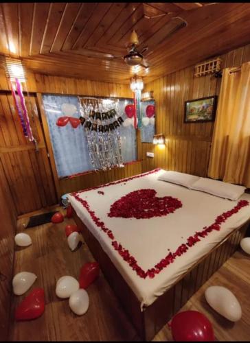 a room with a large bed with red hearts on the floor at Altaf's motel in Matheran