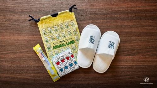 a pair of white shoes and a bag on a table at Daiwa Roynet Hotel Morioka in Morioka