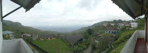 a view of a town on a hill with houses at Choice hotels in Haputale