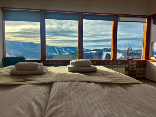 a bedroom with a bed with a view of a mountain at Michałówka na Kubalowej Łące in Szczyrk