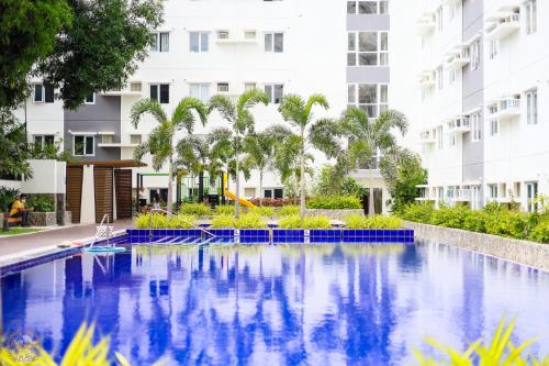 a swimming pool in front of a building at Cozy Home II in Cebu City