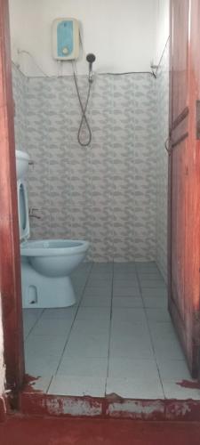 a bathroom with a toilet and a camera on the wall at Choice hotels in Haputale