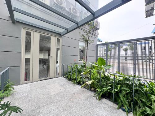 a balcony with plants and a building at Lá Riverside Boutique Hotel in Mỹ Phước