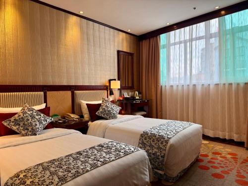 Postel nebo postele na pokoji v ubytování Macau Masters Hotel