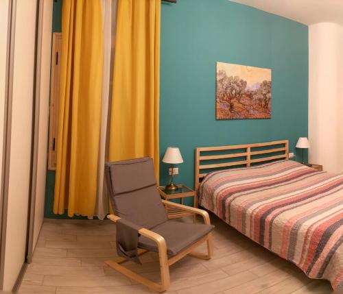 a bedroom with a bed and a chair next to a bed at Lucky Lake in Verbania