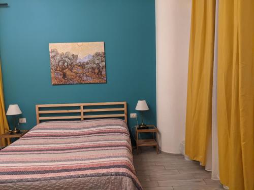 a blue bedroom with a bed and a painting on the wall at Lucky Lake in Verbania