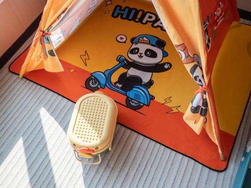 a childs play tent with a panda bear on a scooter at Guanghan Exhibition International Hotel in Guanghan