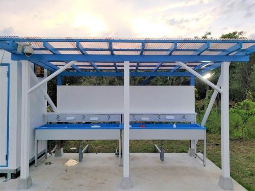 a gas station with a blue roof at Neo Grand in Minamiboso