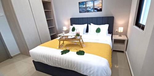 a bedroom with a large bed with a table at LS Iconic Regency #Queensbay Mall#FIZ#Airport in Bayan Lepas