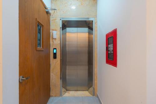 a walkway with a door and a hallway with a elevator at ORCHID Hotel in Da Lat