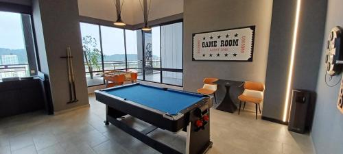 a room with a pool table in a room with windows at LS Iconic Regency #Queensbay Mall#FIZ#Airport in Bayan Lepas