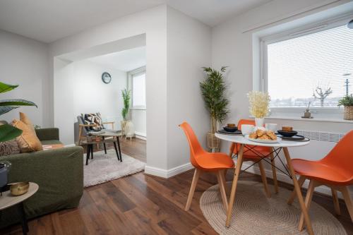 a living room with a table and chairs and a couch at Cozy Waterfront Apartment - Free Parking & Wi-Fi in Preston