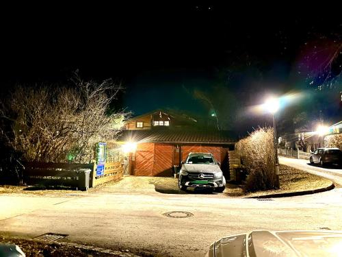a car parked in front of a house at night at Landhaus de Gaspary in Seehausen am Staffelsee