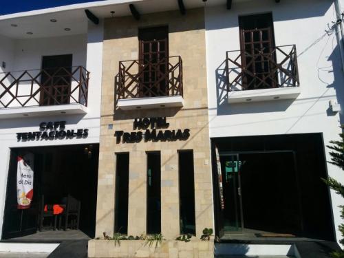 a building with two balconies on the side of it at Hotel Tres Marías in San Cristóbal de Las Casas