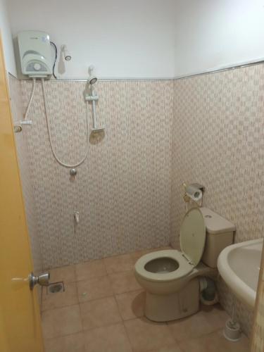 a bathroom with a toilet and a sink and a shower at Rock View Holiday Bungalow in Matale