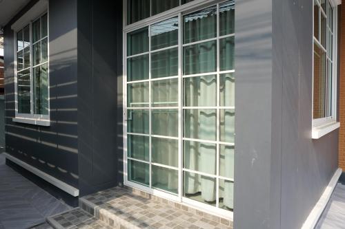 a group of windows on the side of a building at Family Friendly Home in Bangna