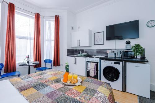 a kitchen with a table with a plate of fruit on it at Jephsons Lodge Studio 1 - Free Parking, WiFi, Netflix in Leamington Spa