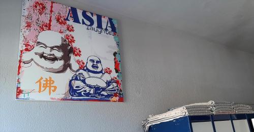 a picture on a wall with a poster on it at Santander Central Hostel in Santander