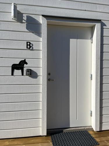 a garage door with a black horse on it at Cozy apartments in Falun - 2km from centrum in Falun