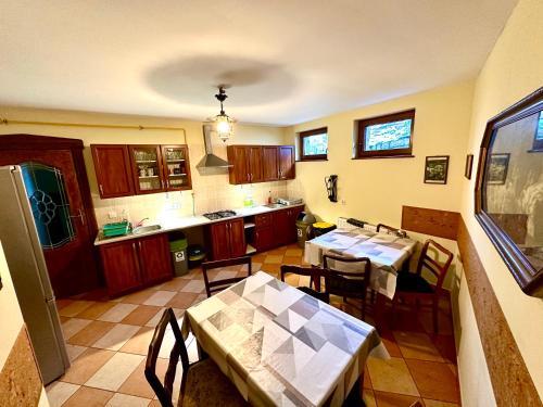 a kitchen with tables and chairs in a room at Kwatery Prywatne-Willa "Nadzieja" in Świeradów-Zdrój