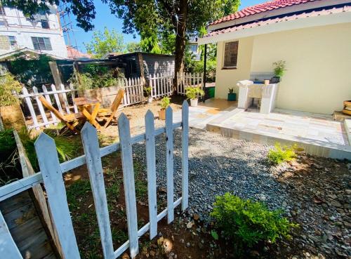 a white picket fence in front of a house at Beautiful, affordable 1bdrm in Milimani in Kisumu