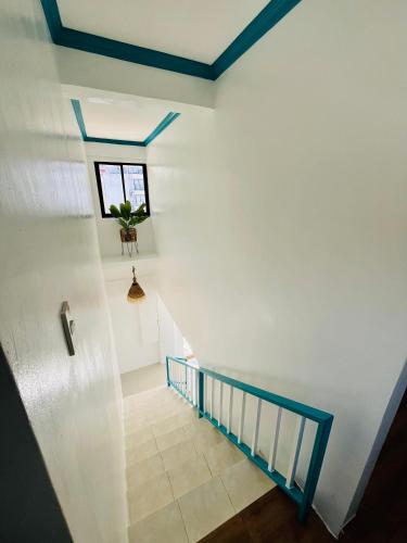 a stairway with a window and a potted plant at Caleo Boracay Island Station 3 in Boracay