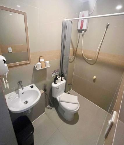 a bathroom with a toilet and a sink at Caleo Boracay Island Station 3 in Boracay