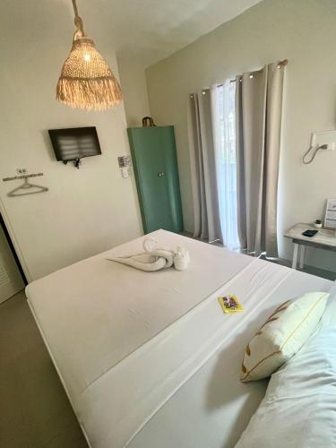 a room with a bed with a towel on it at Caleo Boracay Island Station 3 in Boracay