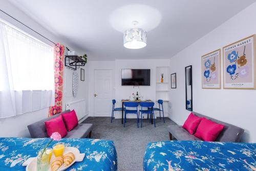 a living room with two beds and a table at Jephsons Lodge Studio 3 - Free Netflix, Parking, WiFi in Leamington Spa